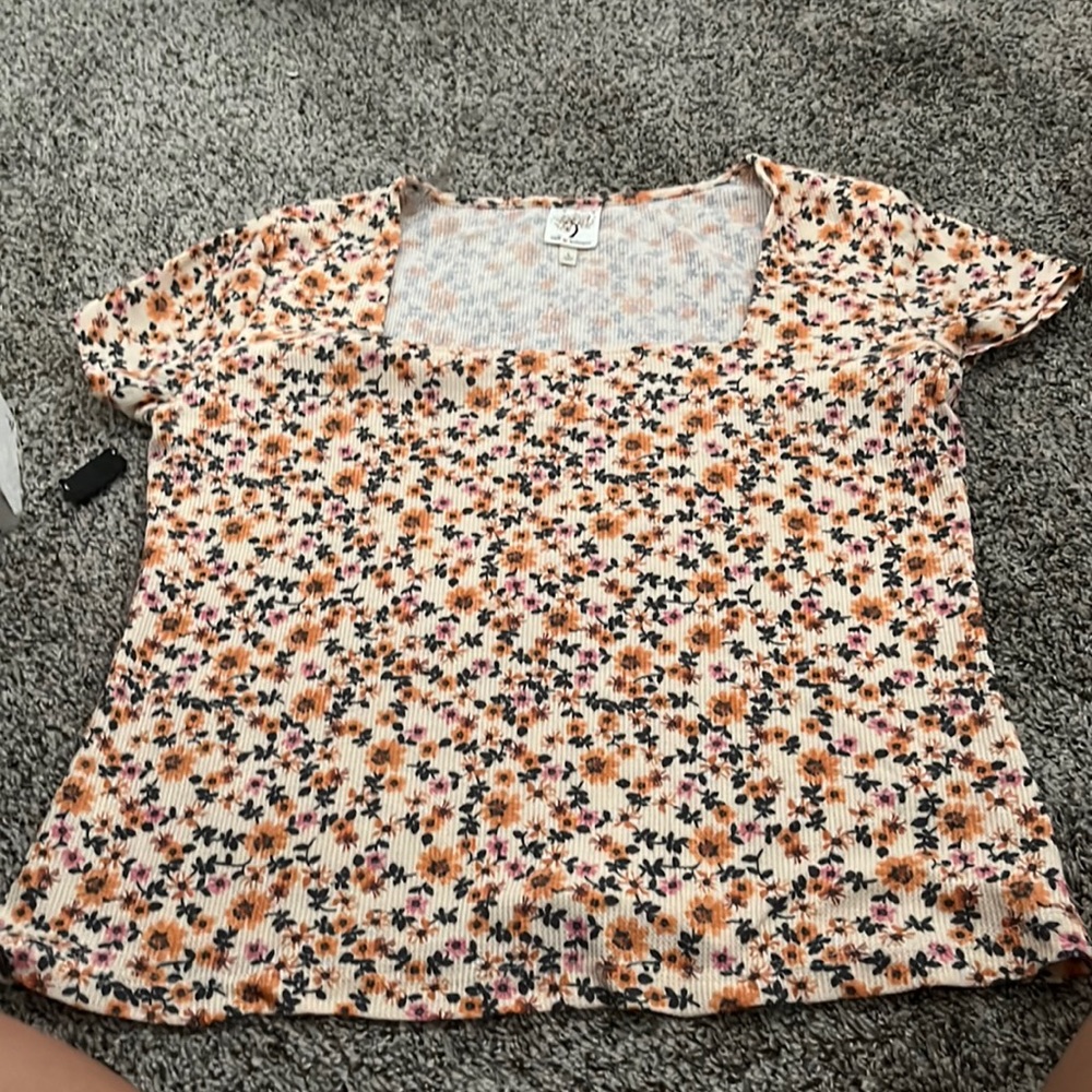 A flower shirt, with square neck, it’s a size large and the brand is self esteem